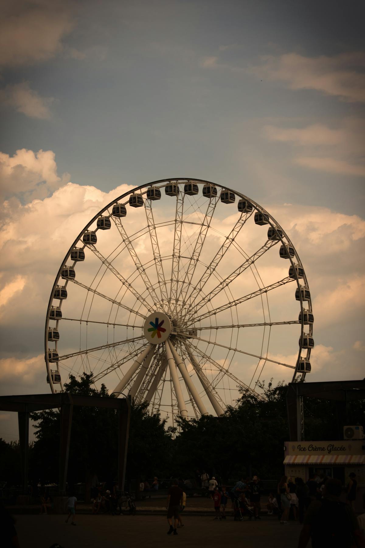 Majestic ferris wheel against cloudy sky at twilight